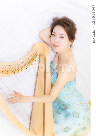 小型ハーブと音楽好きな若い女性 小型ハーブと音楽好きな若い女性 128618047