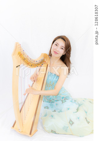 小型ハーブと音楽好きな若い女性 小型ハーブと音楽好きな若い女性 128618307