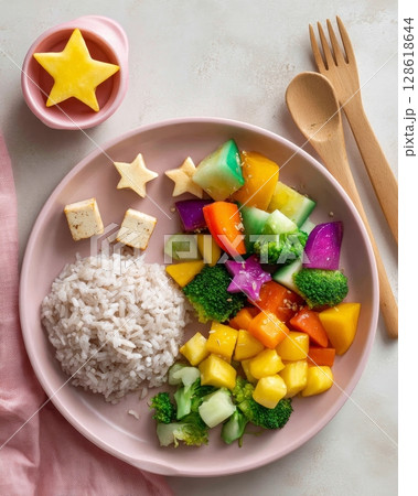 Colorful vegetable and rice plate with tofu and star-shaped cheese for a healthy meal. 128618644