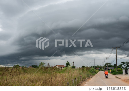 An arcus cloud appear on the sky. Arcus clouds are spectacular low-level, long and thin clouds associated with powerful thunderstorms. An arcus cloud appear on the sky. Arcus clouds are spectacular low-level, long and thin clouds associated with powerful thunderstorms. 128618838