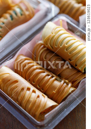 Stack of pancake roll filled with assorted filling. Stack of pancake roll filled with assorted filling. 128619023