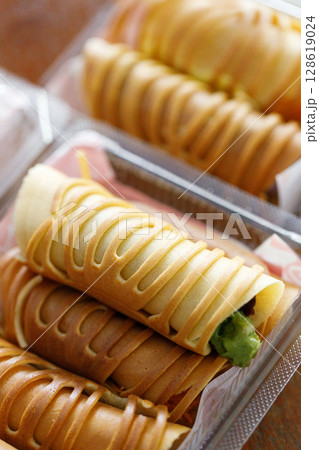 Stack of pancake roll filled with assorted filling. 128619024