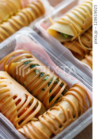 Stack of pancake roll filled with assorted filling. 128619025