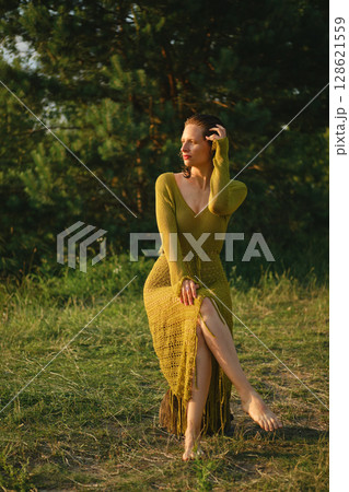 Enjoying a hot summer day by the lake while dressed in a stylish outfit 128621559