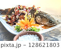 Fried Snakehead Fish in Spicy Herb Salad 128621803