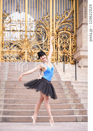 Ballerina posing gracefully near golden gate of Petit Palais Paris June 2025 128622029