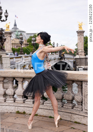 Ballerina posing on Pont Alexandre III in Paris with arms outstretched Ballerina posing on Pont Alexandre III in Paris with arms outstretched 128622180