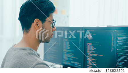 Closeup young adult Asia male freelance eyeglasses typing write prompt AI bot IT app program nomad, video game, terminal with coding, user interface, designer, big data center on desktop computer. 128622591