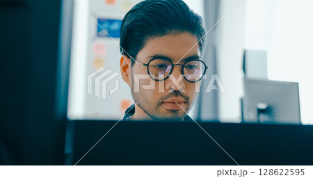 Closeup young adult Asia male freelance eyeglasses typing write prompt AI bot IT app program nomad, video game, terminal with coding, user interface, designer, big data center on desktop computer. Closeup young adult Asia male freelance eyeglasses typing write prompt AI bot IT app program nomad, video game, terminal with coding, user interface, designer, big data center on desktop computer. 128622595