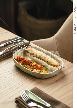 Grilled chicken skewer with spicy sauce Grilled chicken skewer with spicy sauce 128622686