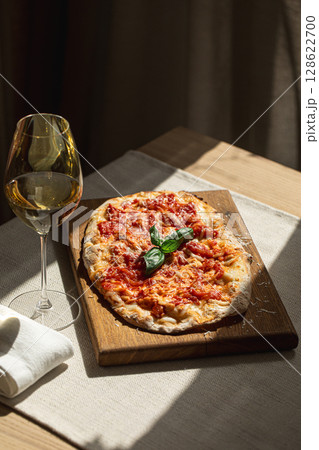 Pinsa margherita with tomato, cheese and basil 128622700
