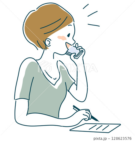 携帯電話で話しながらメモをとる女性 携帯電話で話しながらメモをとる女性 128623576