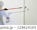 Men's hands paint walls with a roller, work painting on the surface, painting walls in an apartment, repair with white paint. With space to copy. High quality photo 128624165