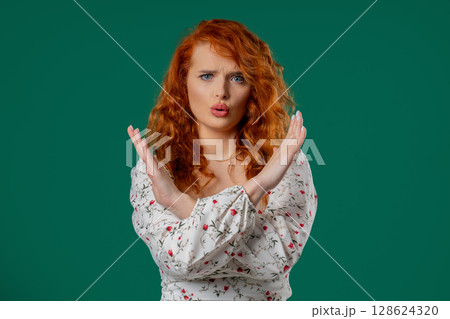 Ginger woman crosses arms in front of chest, express refusal strong disapproval Ginger woman crosses arms in front of chest, express refusal strong disapproval 128624320
