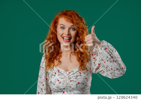 Happy woman gives thumbs up LIKE gesture with excitement and expressive approval Happy woman gives thumbs up LIKE gesture with excitement and expressive approval 128624340