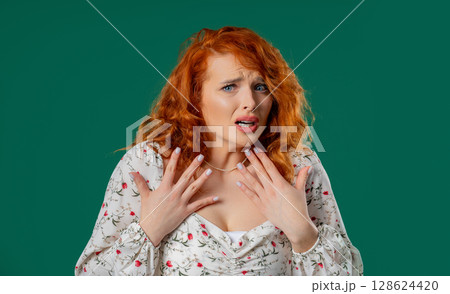 Auburn woman reacts with visible fear, startled while looking directly at camera Auburn woman reacts with visible fear, startled while looking directly at camera 128624420