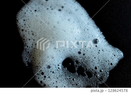 A puddle of soap suds. A puddle of soap suds. 128624578