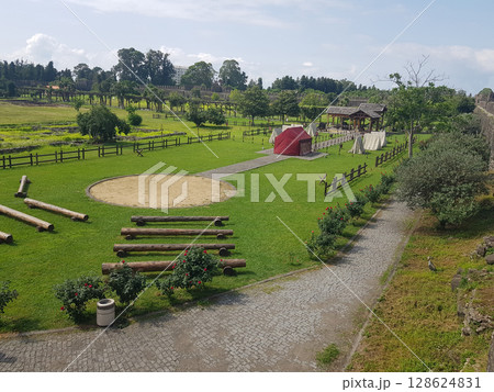 Ancient History. View of Ancient Roman Encampment on Green Grass at Historical Reenactment Ancient History. View of Ancient Roman Encampment on Green Grass at Historical Reenactment 128624831