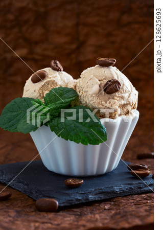 Coffee ice cream in a white bowl. Coffee ice cream in a white bowl. 128625693