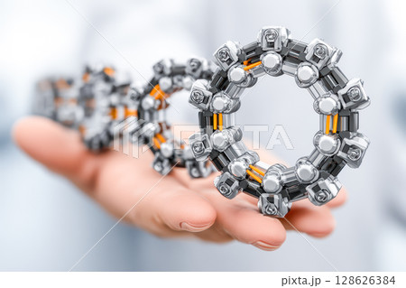 Hand holding futuristic mechanical rings with intricate design and glowing elements for innovation 128626384