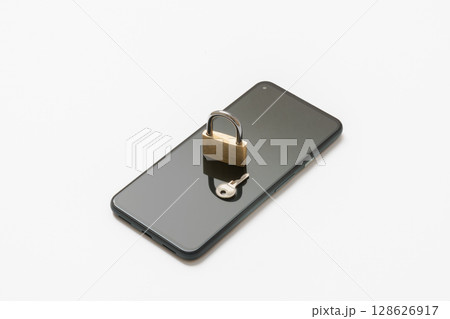 スマートフォンの上に置かれた南京錠　セキュリティイメージ 128626917