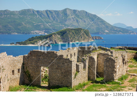 ruins of ancient Fort Mogren in Budva, Montenegro. Sveti Nikola island on backgtound ruins of ancient Fort Mogren in Budva, Montenegro. Sveti Nikola island on backgtound 128627371