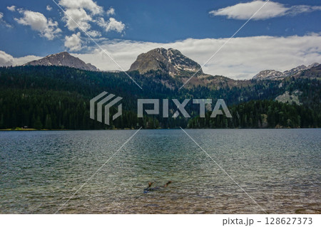 the Black lake with mountainrange in background in Durmitor National Park, Zabljak, Montenegro the Black lake with mountainrange in background in Durmitor National Park, Zabljak, Montenegro 128627373