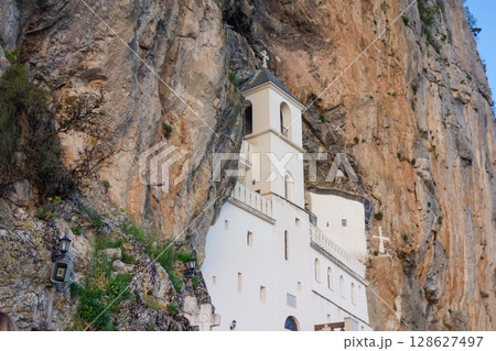 Dabovici, Montenegro - 05.05.2025: Ostrog Monastery, of Serbian Orthodox Church, nestled in rocky hillside 128627497