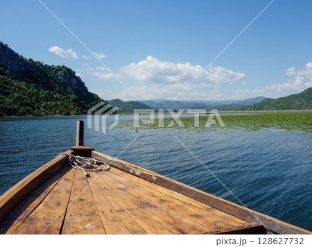 tourist boat sail through Skadar lake, on the border of Albania and Montenegro tourist boat sail through Skadar lake, on the border of Albania and Montenegro 128627732