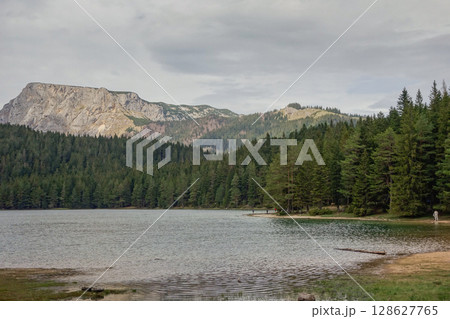 the Black lake with mountainrange in background in Durmitor National Park, Zabljak, Montenegro the Black lake with mountainrange in background in Durmitor National Park, Zabljak, Montenegro 128627765