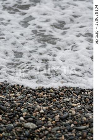 Foam from a wave on a stone beach in Batumi Foam from a wave on a stone beach in Batumi 128628104