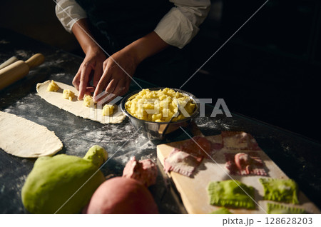 Chef Preparing Handmade Pasta Featuring Colorful Italian Flag-Inspired Dough Chef Preparing Handmade Pasta Featuring Colorful Italian Flag-Inspired Dough 128628203