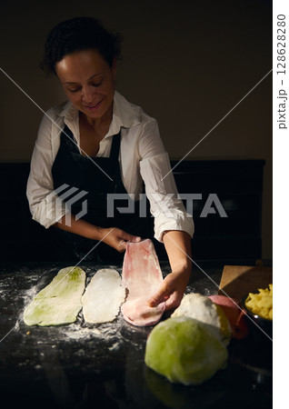 Chef Crafting Pasta Using Colorful Dough Highlighting Italian Culinary Art 128628280