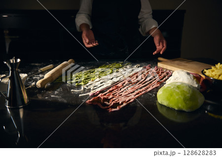 Chef Preparing Colorful Pasta Dough in an Italian Kitchen 128628283