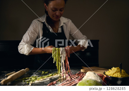 Chef Preparing Multicolored Pasta with Colorful Dough Using Traditional Italian Techniques 128628285