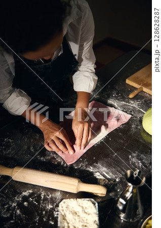 Chef Preparing Colorful Handmade Pasta Ravioli in Rustic Kitchen 128628287