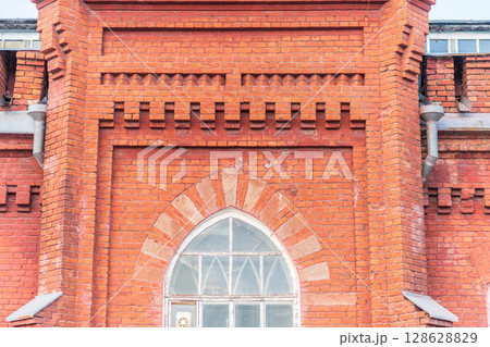 The window of the old mansion 19 century with brown bricks wall 128628829