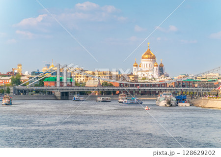 Cruise ship sails on the Moscow river in Moscow city center, popular place for walking. Cruise ship sails on the Moscow river in Moscow city center, popular place for walking. 128629202