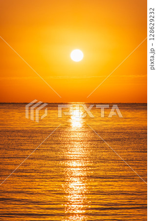Beautiful red and orange sunrise over the sea. Beautiful red and orange sunrise over the sea. 128629232