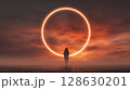 Silhouette stands before a radiant ring. Atmospheric sunset, creating a sense of wonder and mystery. Fantasy and exploration. 128630201