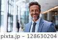 Smiling Business Professional: Confident businessman in a modern office setting, radiating professionalism and success. Focused, determined, and ready for action. 128630204