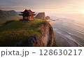 Seaside Temple: A scenic pagoda perches atop a cliff overlooking the ocean at sunset, blending architecture with natural beauty. Serene escape. 128630217