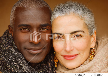 African American man and Caucasian woman smiling together in warm, cozy atmosphere with scarves 128630658