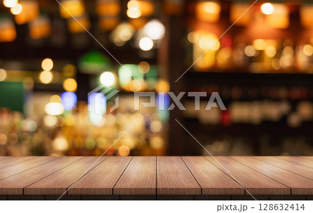Empty wooden table top with lights bokeh on blur restaurant background. Empty wooden table top with lights bokeh on blur restaurant background. 128632414