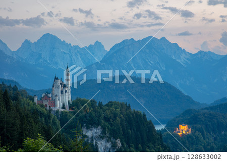 Neuschwanstein Castle at Dusk Surrounded by Rocky Mountains 128633002