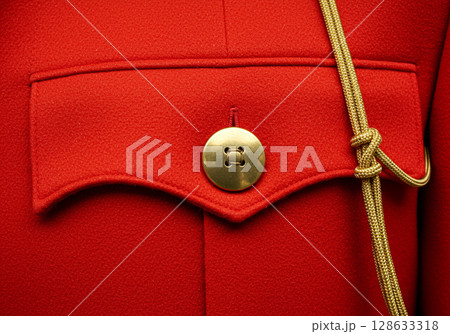 Red military uniform closeup, gold button and cord 128633318