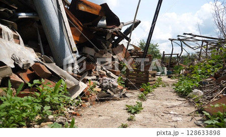 View to destroyed residential buildings at Kharkivska oblast. Ruined houses after bomb attacks on ukrainian territory from russia army. Consequences of russian invasion of Ukraine. Slow motion 128633898