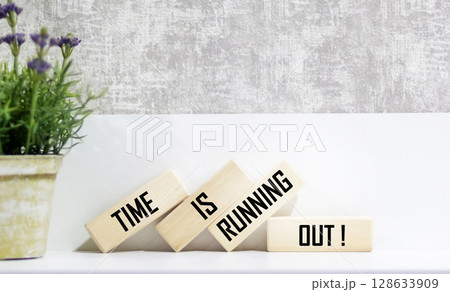 Wooden blocks with the text TIME IS RUNNING OUT on a beautiful background 128633909