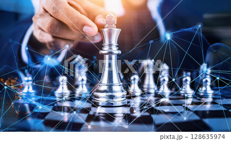 hand moves king piece on chessboard, symbolizing strategy and connection 128635974