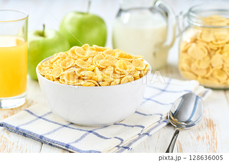 Healthy breakfast with corn flakes and fruits and juice on a white wooden table, selective focus. 128636005